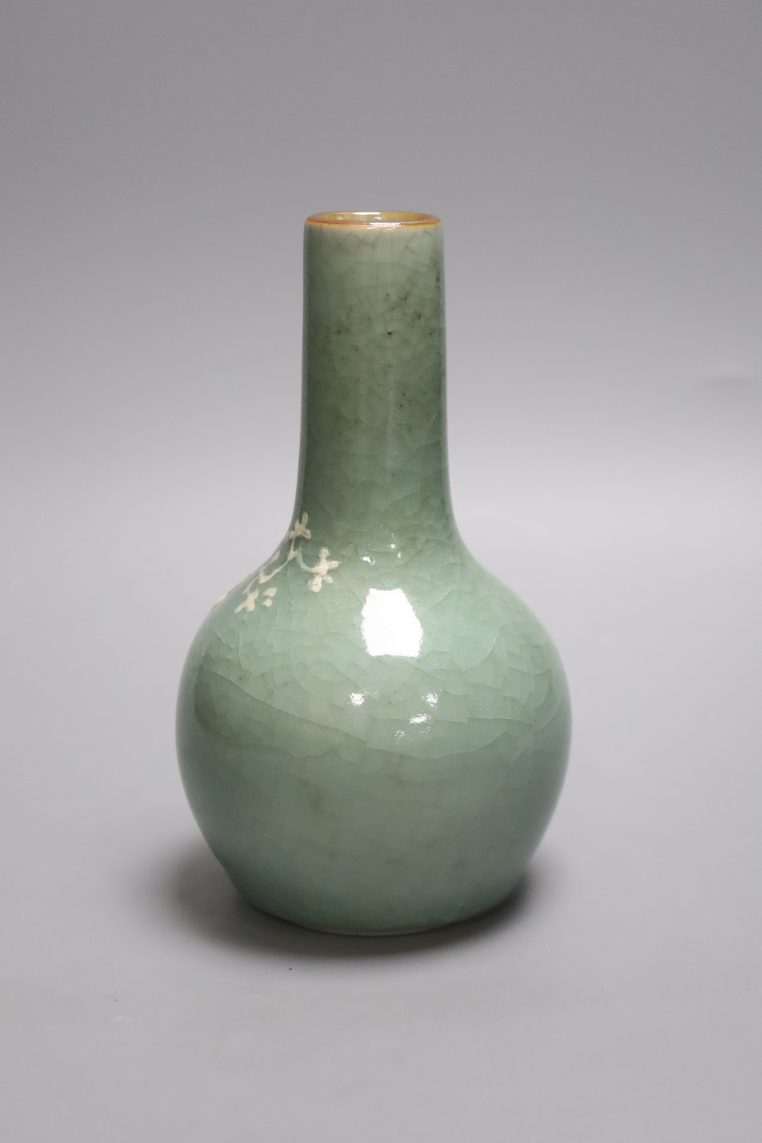 A Chinese celadon bottle vase with white slip decoration, 19th/20th century, height 20cm